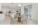 Bright dining area with four chairs and access to back patio at 5322 Windy Grove Dr, Wimauma, FL 33598