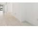 Clean hallway with light neutral tile floors at 5322 Windy Grove Dr, Wimauma, FL 33598