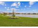Community lake view with homes and lush green landscape at 5322 Windy Grove Dr, Wimauma, FL 33598