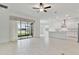 Open living space with access to covered patio and lake view at 5322 Windy Grove Dr, Wimauma, FL 33598