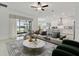 Spacious living room with sectional sofa and view of lake at 5322 Windy Grove Dr, Wimauma, FL 33598