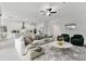Open-concept living area with large sofa and view into kitchen at 5322 Windy Grove Dr, Wimauma, FL 33598