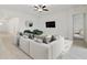 Bright living room with comfy seating and a large TV at 5322 Windy Grove Dr, Wimauma, FL 33598