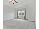 Bright main bedroom with neutral carpeting and ceiling fan at 5322 Windy Grove Dr, Wimauma, FL 33598
