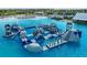 Aqua park with inflatable obstacles in lagoon pool at 5322 Windy Grove Dr, Wimauma, FL 33598