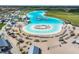 Large lagoon pool with sandy beach and lounge chairs at 5322 Windy Grove Dr, Wimauma, FL 33598