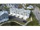 Aerial view of townhouses with gray siding, white trim, and gray roofs at 5736 Biscayne Ct # 3, New Port Richey, FL 34652