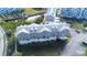 Aerial view of row of townhouses, gray siding, white trim, and gray roofs at 5736 Biscayne Ct # 3, New Port Richey, FL 34652