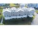Aerial view of townhouses with gray siding, white trim, and gray roofs at 5736 Biscayne Ct # 3, New Port Richey, FL 34652