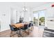 Bright dining area with wooden table and black chairs, offering water views at 5736 Biscayne Ct # 3, New Port Richey, FL 34652