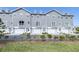 Row of gray townhomes with white garage doors and landscaping at 5736 Biscayne Ct # 3, New Port Richey, FL 34652