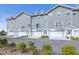 Gray townhouses, white garages, manicured landscaping at 5736 Biscayne Ct # 3, New Port Richey, FL 34652
