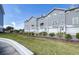 Townhomes with gray siding, white garage doors, and landscaping at 5736 Biscayne Ct # 3, New Port Richey, FL 34652