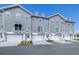 Modern gray townhouses with white garages and landscaping at 5736 Biscayne Ct # 3, New Port Richey, FL 34652