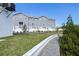 Gray townhomes, green lawn, and a white wall at 5736 Biscayne Ct # 3, New Port Richey, FL 34652