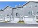 Three-story townhouses, gray siding, white garage doors at 5736 Biscayne Ct # 3, New Port Richey, FL 34652