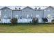 Rear view of townhouses with private yards at 5736 Biscayne Ct # 3, New Port Richey, FL 34652