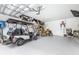 Two-car garage with golf cart and storage at 5736 Biscayne Ct # 3, New Port Richey, FL 34652