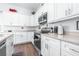 Modern kitchen with white cabinets, stainless steel appliances, and an island at 5736 Biscayne Ct # 3, New Port Richey, FL 34652