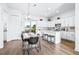 Modern kitchen with white cabinets, island, and dining area at 5736 Biscayne Ct # 3, New Port Richey, FL 34652