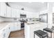 Modern kitchen with white cabinets, stainless steel appliances, and an island at 5736 Biscayne Ct # 3, New Port Richey, FL 34652