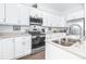 Modern kitchen with white cabinets, stainless steel appliances, and an island at 5736 Biscayne Ct # 3, New Port Richey, FL 34652