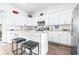 Modern kitchen with white cabinets, stainless steel appliances, and an island at 5736 Biscayne Ct # 3, New Port Richey, FL 34652