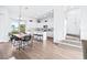 Modern kitchen with white cabinets, island, and dining area at 5736 Biscayne Ct # 3, New Port Richey, FL 34652