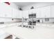 Modern kitchen with white cabinets, stainless steel appliances, and an island at 5736 Biscayne Ct # 3, New Port Richey, FL 34652
