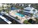 Relaxing community pool area with surrounding tropical landscaping at 5736 Biscayne Ct # 3, New Port Richey, FL 34652
