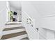 Modern white and wood staircase leading to the second floor at 5736 Biscayne Ct # 3, New Port Richey, FL 34652