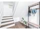 Modern staircase with white railings and dark wood steps at 5736 Biscayne Ct # 3, New Port Richey, FL 34652