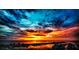Dramatic sunset over coastal city, showcasing vibrant colors and water views at 670 Island Way # 500, Clearwater Beach, FL 33767