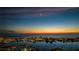 Night aerial view of coastal city, marina, and ocean with a crescent moon in the sky at 670 Island Way # 500, Clearwater Beach, FL 33767