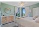 Bright bedroom with a dresser, a queen-size bed, and balcony access at 670 Island Way # 500, Clearwater Beach, FL 33767