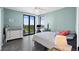 Bedroom with a queen-size bed, a dresser, and views of lush greenery at 670 Island Way # 500, Clearwater Beach, FL 33767