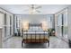 Relaxing bedroom with a metal bed frame and ceiling fan at 670 Island Way # 500, Clearwater Beach, FL 33767