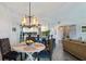 Charming dining area with a rustic table and modern chandelier at 670 Island Way # 500, Clearwater Beach, FL 33767