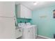 Laundry room with washer, dryer, and extra storage cabinets at 670 Island Way # 500, Clearwater Beach, FL 33767