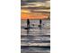 Silhouette of paddleboarders at sunset, enjoying the tranquil ocean waters at 670 Island Way # 500, Clearwater Beach, FL 33767