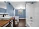 Modern bathroom with subway tile and wood vanity at 705 Whiteway Dr, Brooksville, FL 34601
