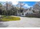 A-frame house with a long driveway and wooden fence at 705 Whiteway Dr, Brooksville, FL 34601