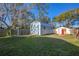 Two storage sheds in a backyard setting with a wooden fence at 705 Whiteway Dr, Brooksville, FL 34601