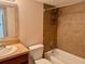 Bathroom with tub, toilet, and wood vanity at 706 Haven Pl, Tarpon Springs, FL 34689