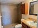 Clean bathroom with shower and a vanity with wood cabinets at 706 Haven Pl, Tarpon Springs, FL 34689