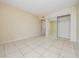 Bright bedroom with tile floors and mirrored closet doors at 706 Haven Pl, Tarpon Springs, FL 34689