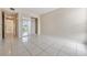 Bedroom with tile floors, mirrored closet, and hallway view at 706 Haven Pl, Tarpon Springs, FL 34689