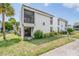 Two-story building exterior, featuring white siding and a balcony at 706 Haven Pl, Tarpon Springs, FL 34689