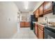 Open kitchen with dark appliances and wood cabinets at 706 Haven Pl, Tarpon Springs, FL 34689