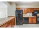 Kitchen with dark appliances and wood cabinets at 706 Haven Pl, Tarpon Springs, FL 34689